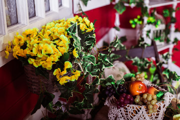 flowers and grapes and apples in a basket