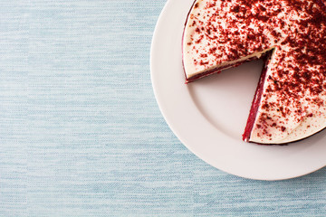 Red Velvet cake slice on blue background. Top view