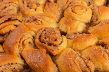 Pie with cinnamon and sugar on a wooden background.