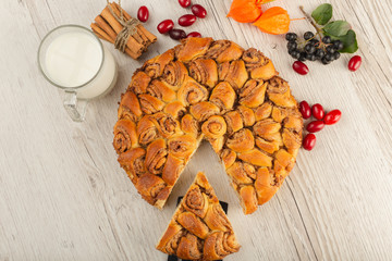 Pie with cinnamon and sugar on a wooden background.