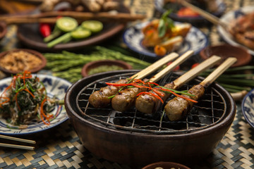Satay or Sate - Malaysian and Indonesian famous food. Satay, modern Indonesian and Malay spelling of sate, is a dish of skewered and grilled meat, served with a peanut sauce.