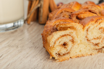 Pie with cinnamon and sugar on a wooden background.