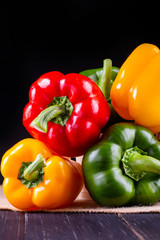 Three sweet peppers on a wooden background, Cooking vegetable salad