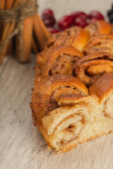 Pie with cinnamon and sugar on a wooden background.