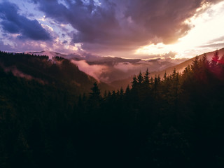 beautiful aerial view of the mountains and the blue lake, the sunset after the rain, the coniferous forest, the purple clouds, Best place in, tourism and nature concept, the Carpathians Ukraine