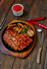 Juicy delicious meat cooked on the grill with vegetables decorated with greenery, a perfect dish meksikansiky hot sauce