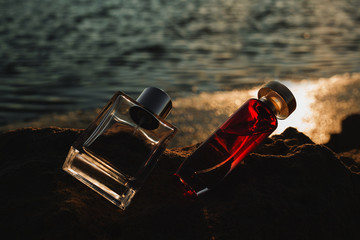 two bottles of perfume at sunset