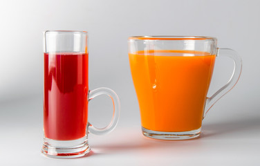 A glass of carrot juice on a white background