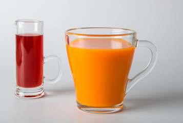 A glass of carrot juice on a white background