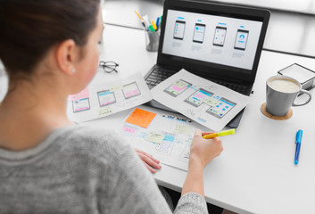 app design, technology and business concept - web designer or developer with sketches and laptop...