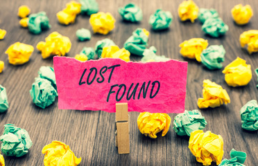 Writing note showing Lost Found. Business photo showcasing Things that are left behind and may retrieve to the owner Clothespin holding pink note paper crumpled papers several tries