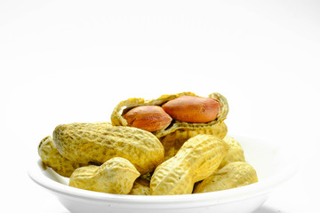 Peanuts isolated on the white background. Close up in blow