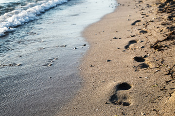 Fototapeta na wymiar footprints on sandy beach and beautiful sea waves, patara beach, turkey