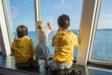 Beautiful children, on board on ferry, traveling for a vacation