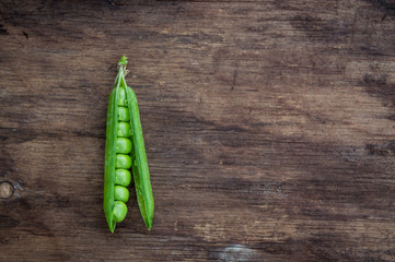 Pea pod on wooden background