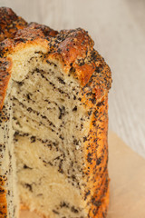 Cake with poppy in a cut on a wooden background.