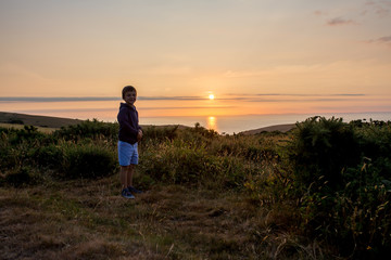Children enjoying Sunset over the ocean from the hills of Exmoor