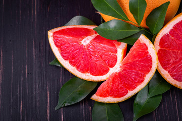 orange and grapefruit juice On a wooden black background