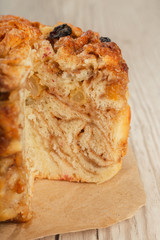 Pie with cinnamon in a cut on a wooden background.