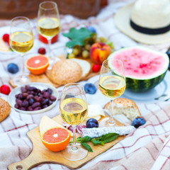 Fototapeta na wymiar Summer Picnic Basket on the Green Grass. Food and drink concept. Friends Party time