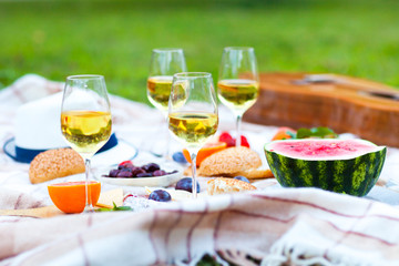 Summer Picnic Basket on the Green Grass. Food and drink concept. Friends Party time