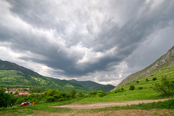 Early morning thunder storm clouds  over a mountain peak, where tourists climb to conquer fear, find courage and develop lateral thinking skills to overcome the difficulty of climbing a mountain.  
