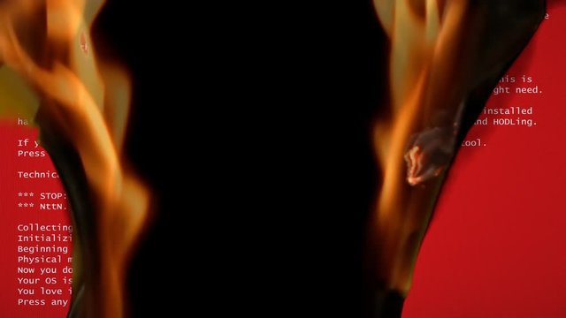 A funny fake BSOD (red error screen) failure message, recreated by me with a comedic meaning, slowly destroyed by intense flames.
