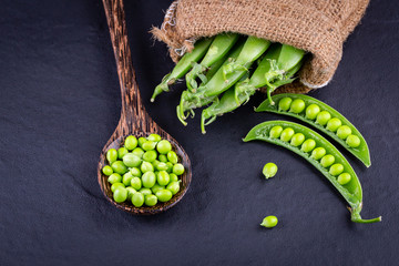 Sugar snap peas with mint on a rustic wood background
