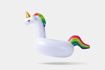 Inflatable unicorn pool toy on white background. Minimal summer concept. © Paopano