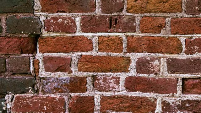Old and torn surface of brick wall. Traveling left to right after a while. Animated still picture.