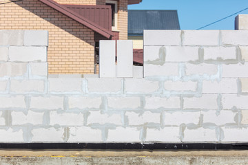 Fototapeta na wymiar Brick wall in a house under construction