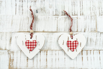 Two hearts of wood on wooden background