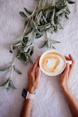 Cup of cappuccino and flowers.