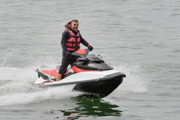 Fototapeta na wymiar man riding a jet ski