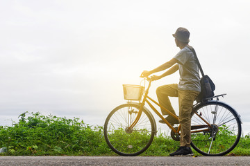 Obraz premium Man riding a bicycle in countryside.