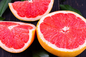 orange and grapefruit juice On a wooden black background