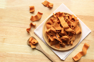 Crispy noodle snack in the wooden bowl on table, Sodium diet high risk kidney failure, Healthy Eating