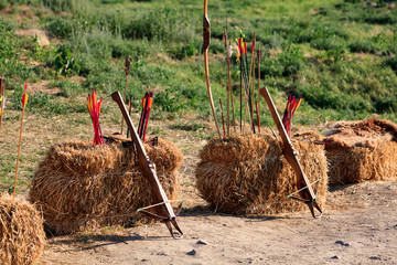 Crossbows, bow and arrows on the straw blocks