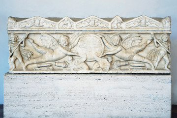 Bas-relief of an ancient Roman sarcophagus depicting cupid angels in the the public Baths of Diocletian in Rome, Italy. It was built from 298 to 306