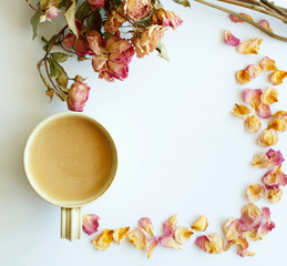 Picture of autumn background with dry roses and cup of coffee with copy space over white background