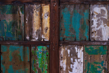 Abstract grunge wood texture background. Patterned and textures background of brightly colored panels of weathered painted wooden boards. Vintage wooden wall with peeling  paint.