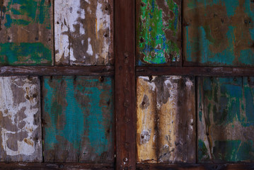 Abstract grunge wood texture background. Patterned and textures background of brightly colored panels of weathered painted wooden boards. Vintage wooden wall with peeling  paint.