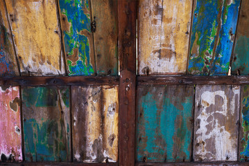 Abstract grunge wood texture background. Patterned and textures background of brightly colored panels of weathered painted wooden boards. Vintage wooden wall with peeling  paint.