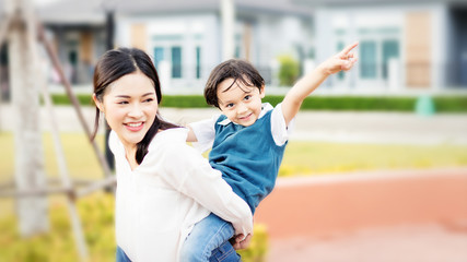 Mother and kids are going to send their children to the school bus.Kids shoulder schoolbag.Back to...