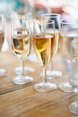 Champagne glasses on wooden table. Selective focus and shallow depth of field.