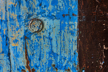 Dark worn rusty metal texture background.  Old worn metal surface with paint.  Metal sheet with rust and worn paint. Background. Metal. Wall. Rusty metal surface with blue and brown cracked paint.