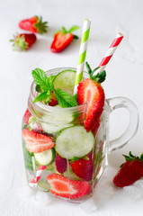 Summer refreshing iced drinks with cucumber and strawberry on white background