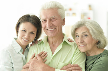 Happy senior parents with daughter at home 