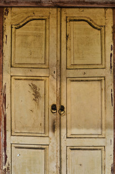 Beautiful old wooden door with ornaments at old city. Ancient carving wooden. Vintage background.