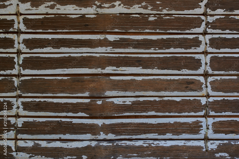 Wall mural Vintage wooden texture of white painted natural old grunge dirty aged bamboo wood planks with gaps, close up. Bamboo fence background.